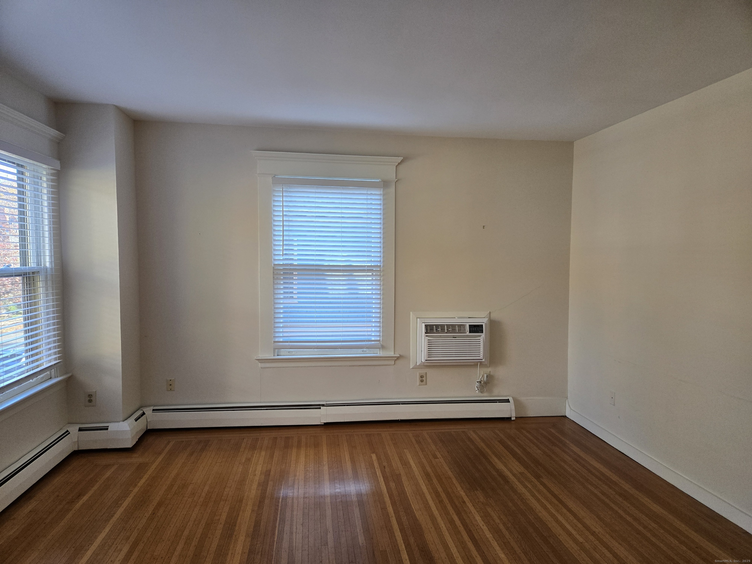 188 Cold Spring Street, Unit 3 New Haven, CT 06511 - Photo 9 of 20 an empty room with wooden floor and windows