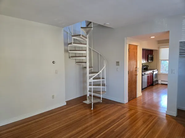 a view of a room with wooden floor and stairs