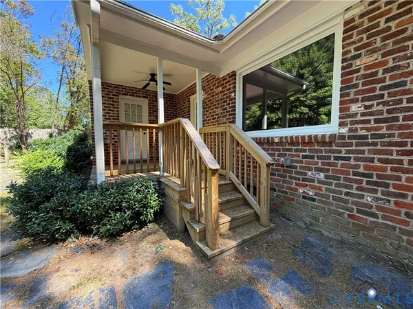 a kitchen with stainless steel appliances granite countertop a refrigerator a sink dishwasher a stove and a dining table with wooden floor