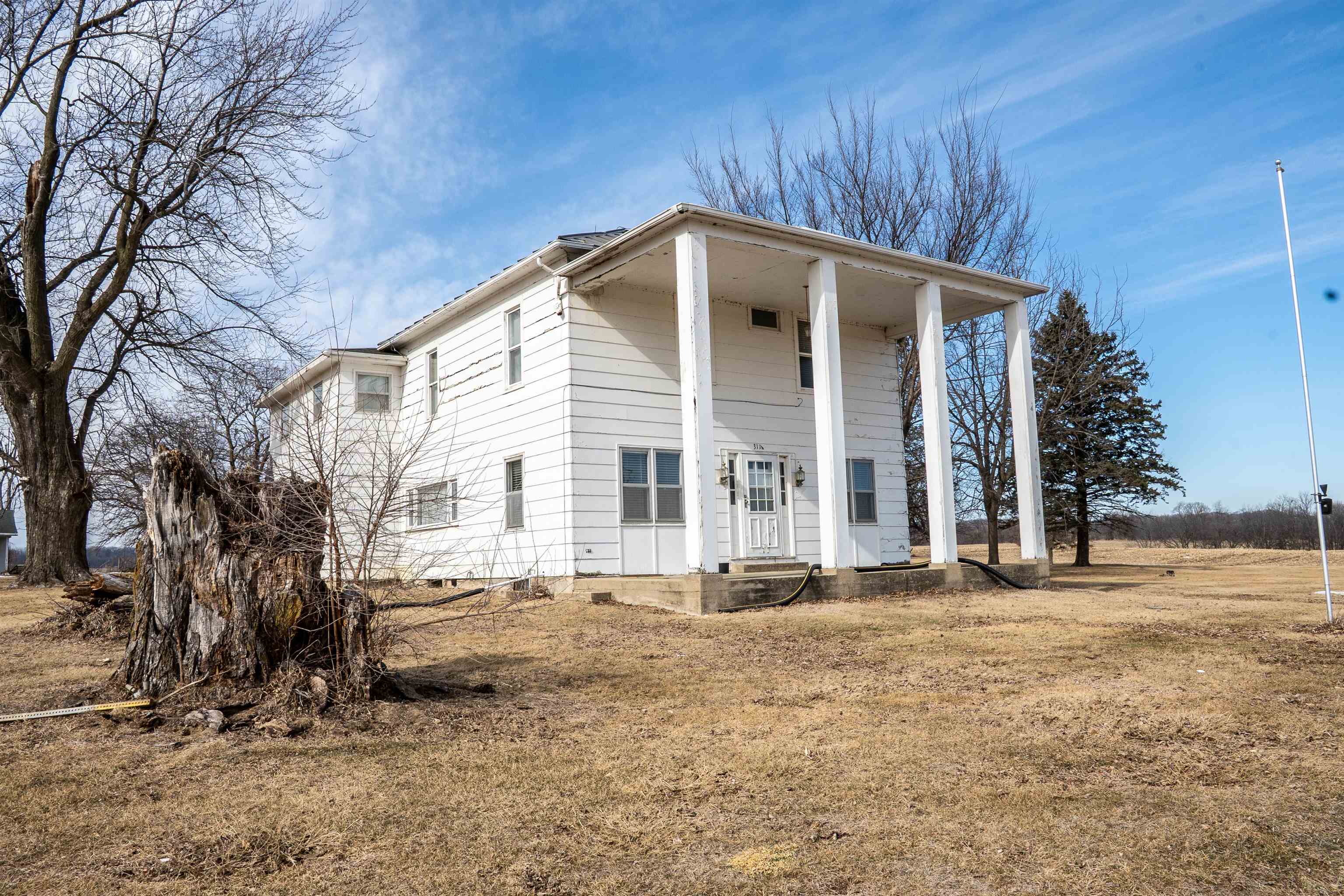 a view of a house with a yard covered in snow