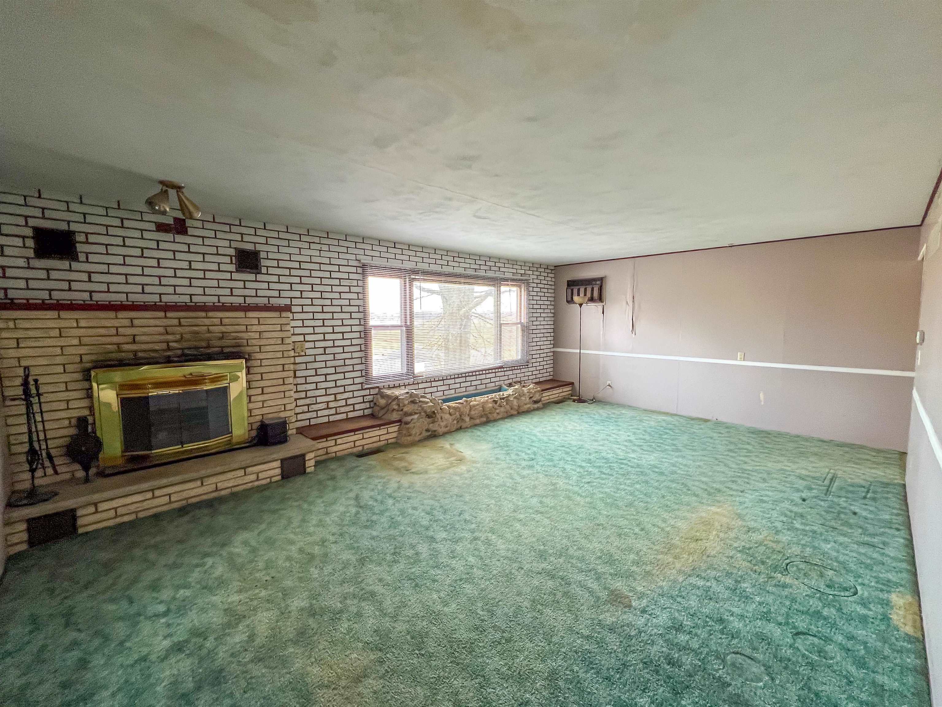 3114 South Rush Creek Road Stockton, IL 61085 - Photo 11 of 76 a view of an empty room with a fireplace and a window