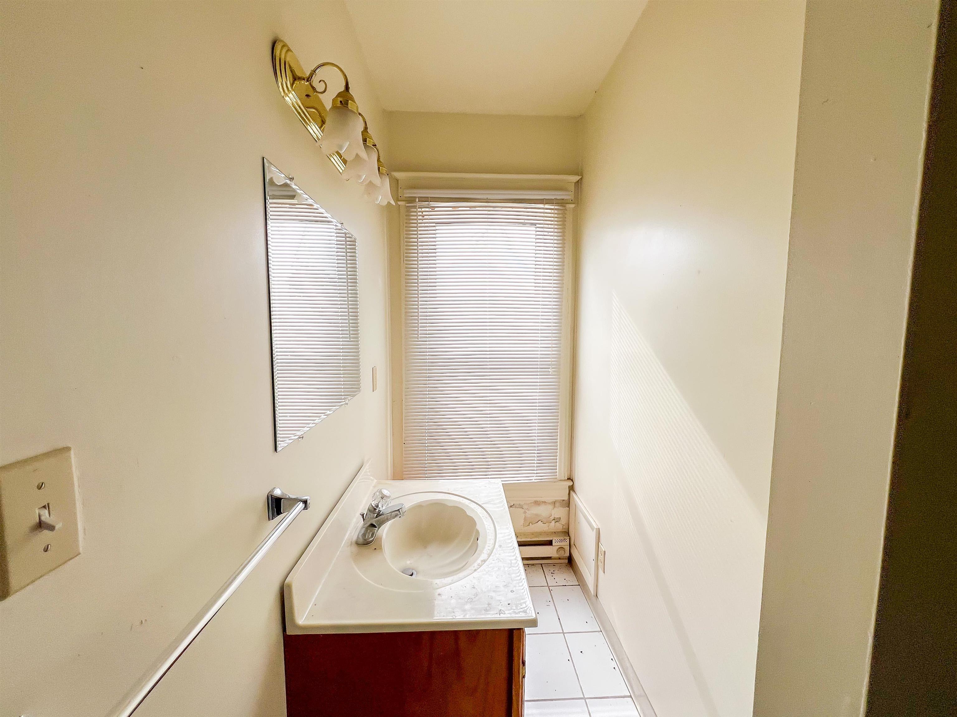 3114 South Rush Creek Road Stockton, IL 61085 - Photo 12 of 76 a bathroom with a sink and a mirror