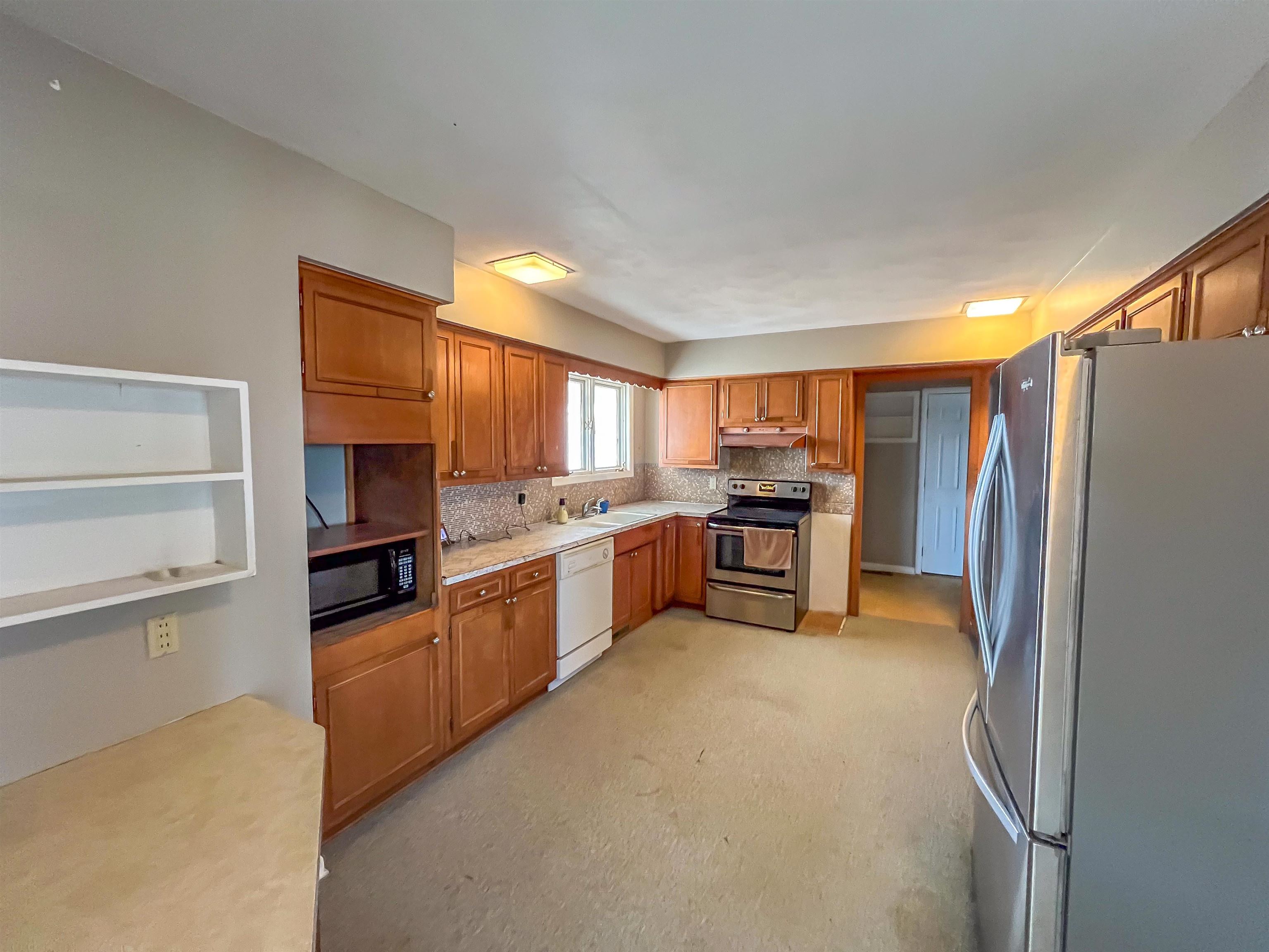 3114 South Rush Creek Road Stockton, IL 61085 - Photo 13 of 76 a kitchen with stainless steel appliances a refrigerator sink and cabinets