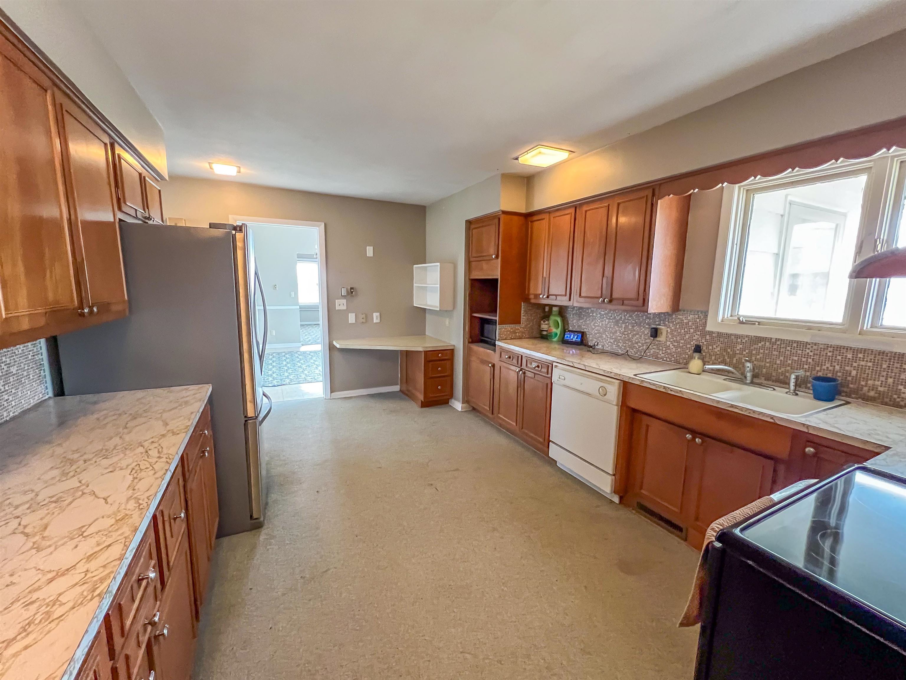 3114 South Rush Creek Road Stockton, IL 61085 - Photo 14 of 76 a kitchen with stainless steel appliances granite countertop a sink refrigerator and cabinets
