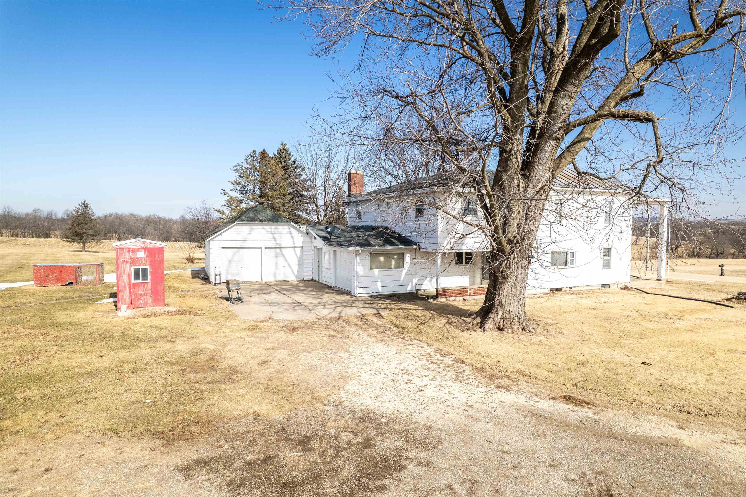 3114 South Rush Creek Road Stockton, IL 61085 - Photo 17 of 76 a tall yellow house with a tree in front of it