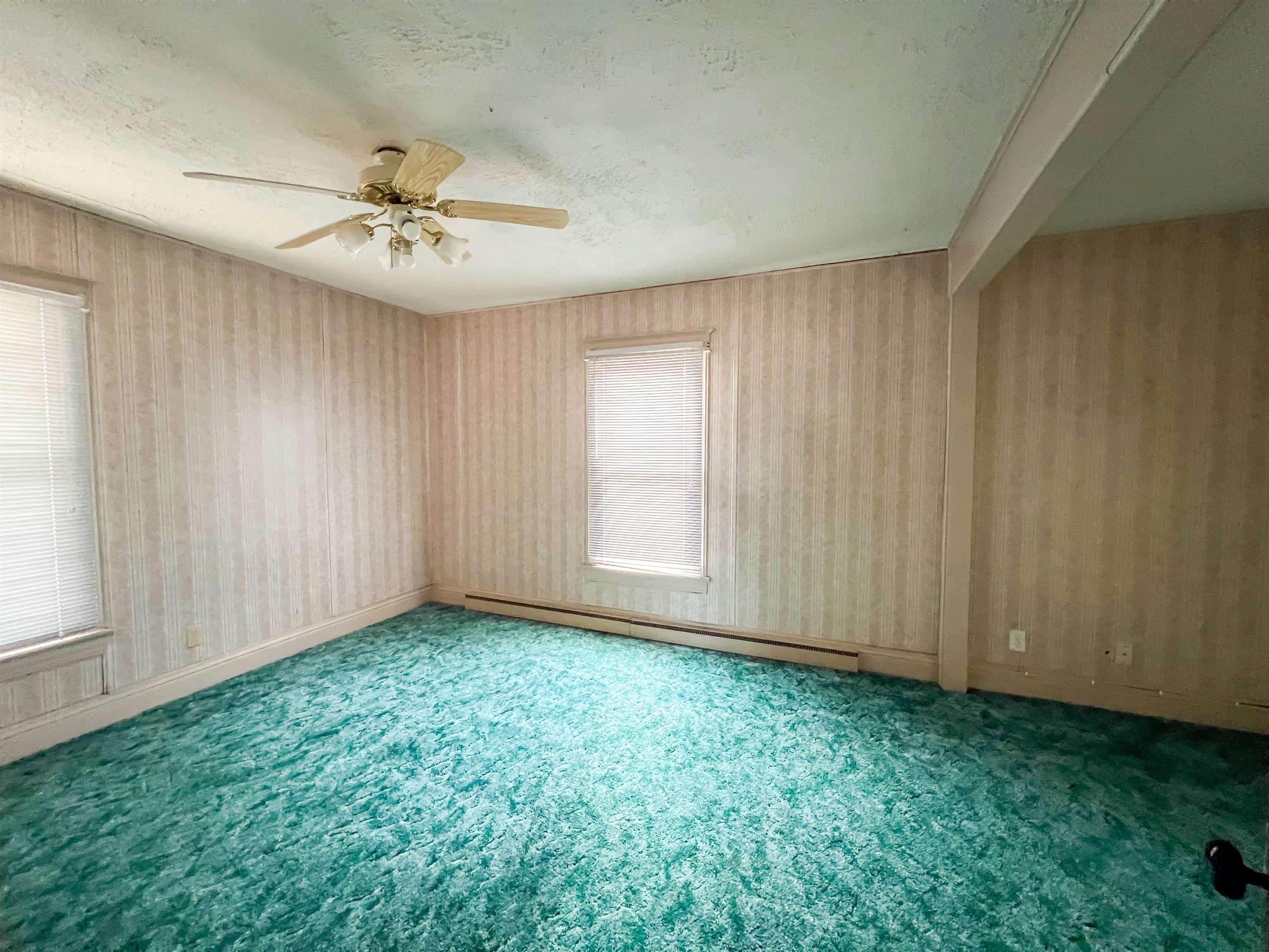 3114 South Rush Creek Road Stockton, IL 61085 - Photo 23 of 76 an empty room with a window and a fan