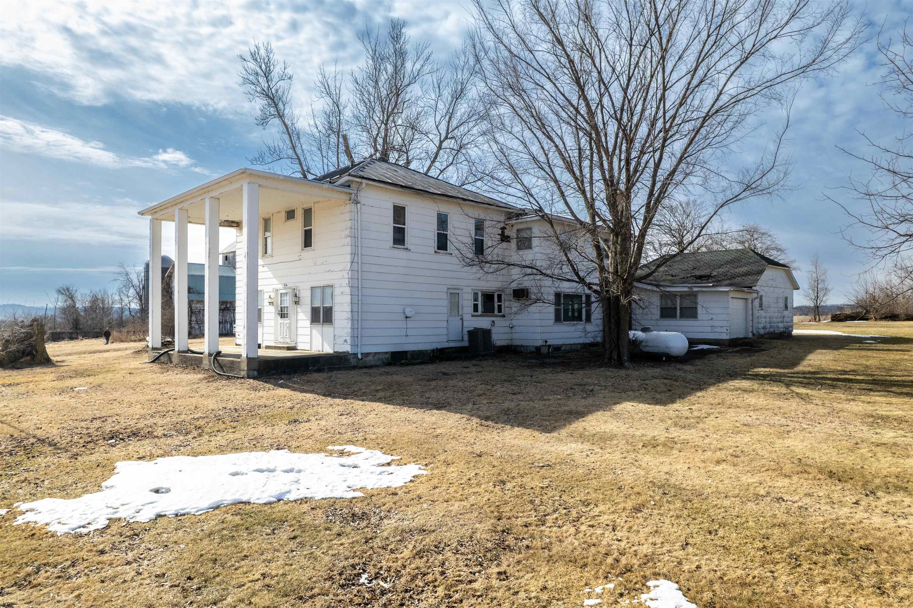 3114 South Rush Creek Road Stockton, IL 61085 - Photo 53 of 76 a front view of a house with a yard covered in snow