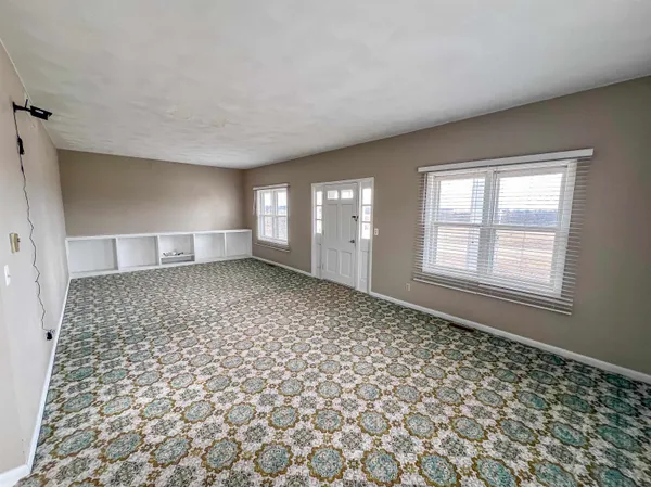 an entryway at a room with a chandelier and closet