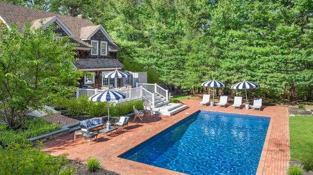 swimming pool view with a seating space
