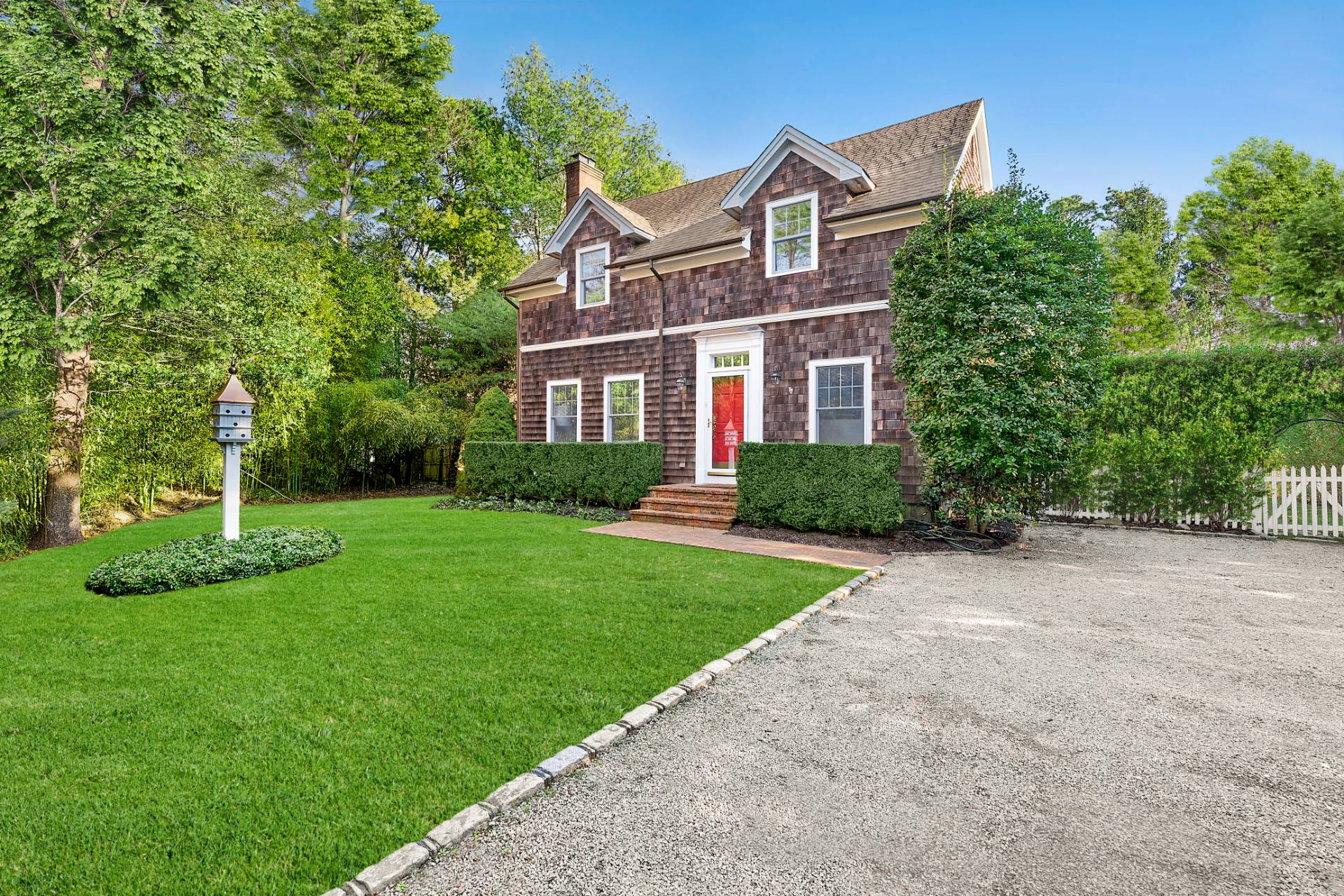 63 Whooping Hollow Road East Hampton, NY 11937 - Photo 3 of 25 a front view of a house with a yard