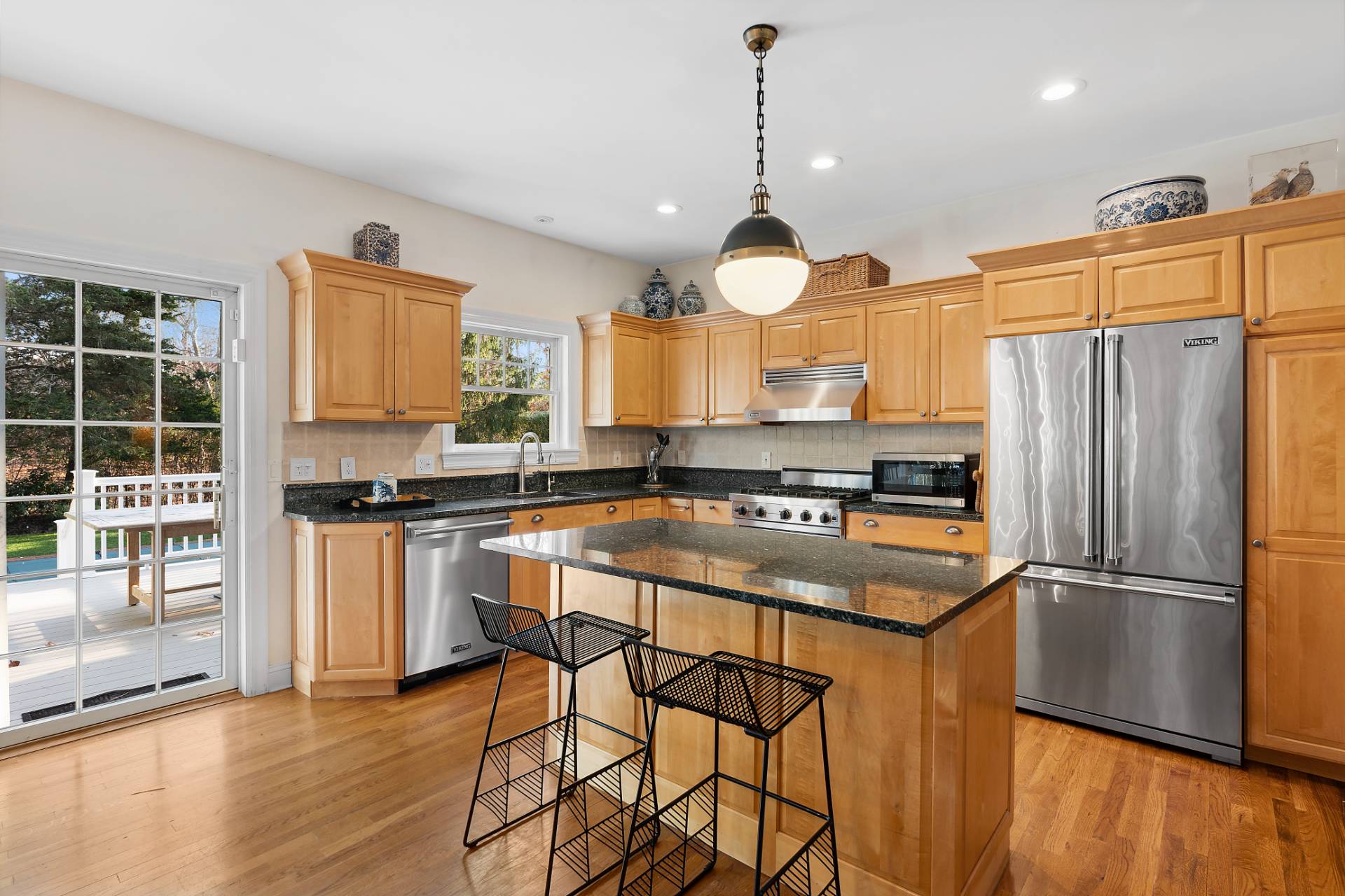 63 Whooping Hollow Road East Hampton, NY 11937 - Photo 6 of 25 a kitchen with stainless steel appliances granite countertop a stove a sink dishwasher and a refrigerator with wooden floor