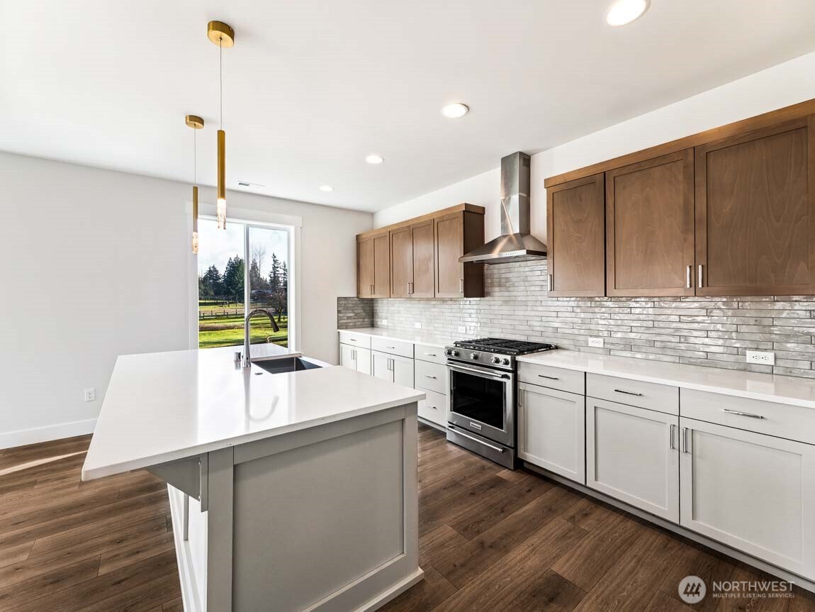 25012 181st Avenue Southeast, Unit 5 Covington, WA 98042 - Photo 12 of 34 a kitchen with stainless steel appliances granite countertop a sink stove and refrigerator