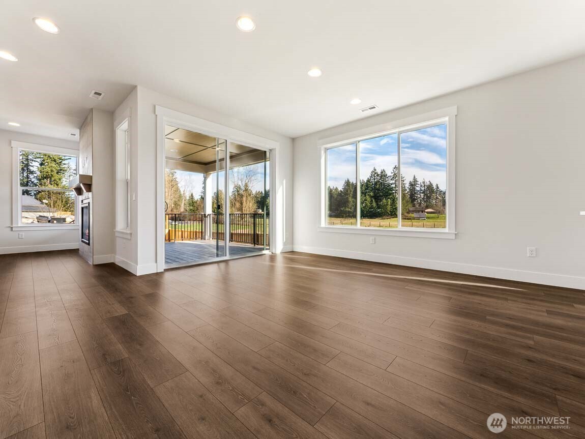 25012 181st Avenue Southeast, Unit 5 Covington, WA 98042 - Photo 13 of 34 an empty room with wooden floor and windows