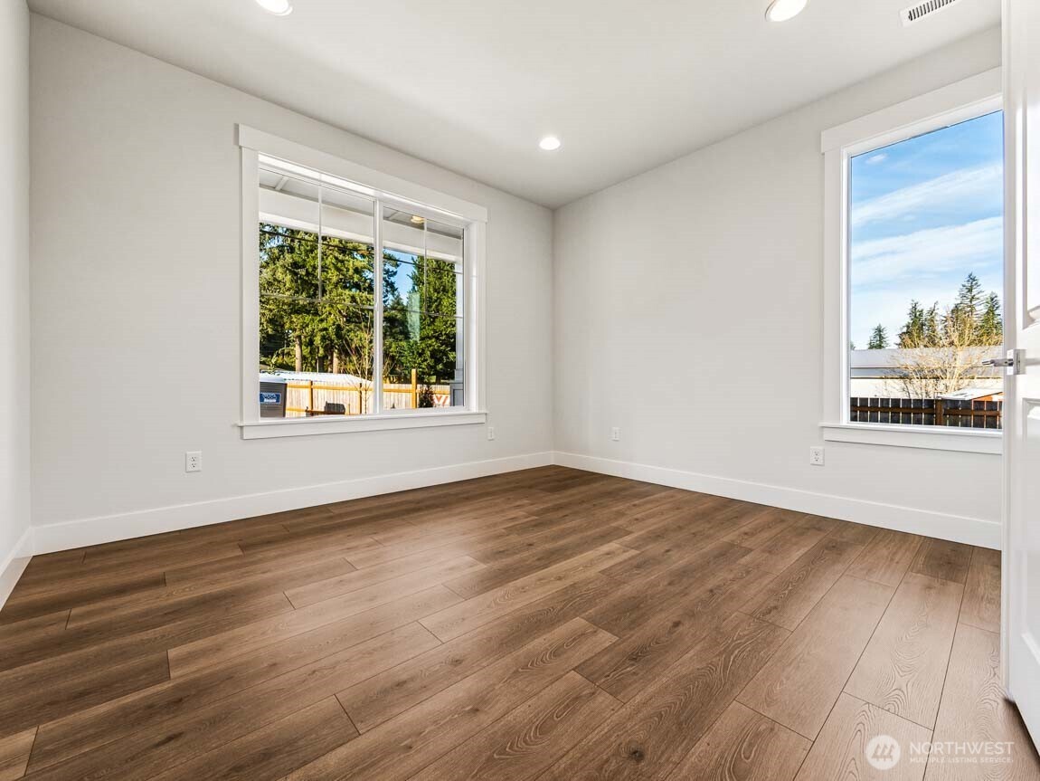 25012 181st Avenue Southeast, Unit 5 Covington, WA 98042 - Photo 15 of 34 a view of an empty room with wooden floor and a window