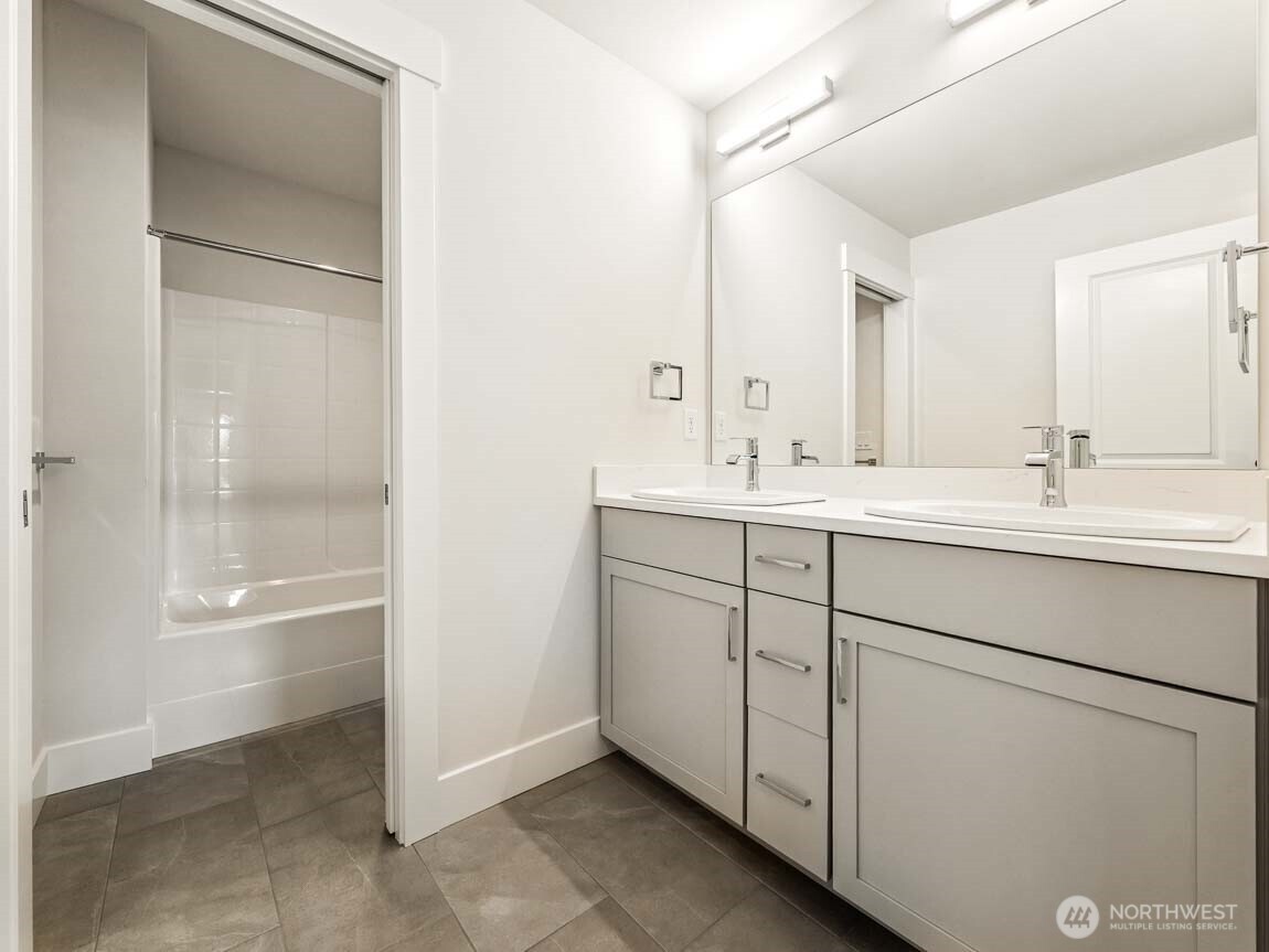 25012 181st Avenue Southeast, Unit 5 Covington, WA 98042 - Photo 23 of 34 a bathroom with a shower sink and mirror