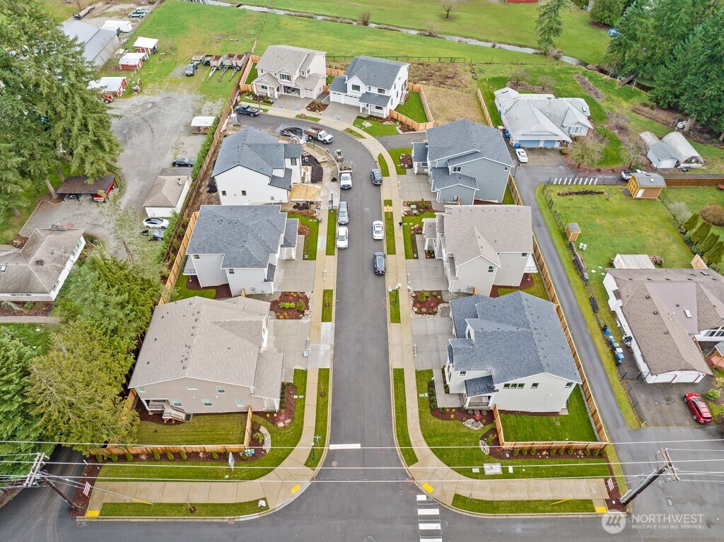 25012 181st Avenue Southeast, Unit 5 Covington, WA 98042 - Photo 32 of 34 an aerial view of residential houses with outdoor space and swimming pool