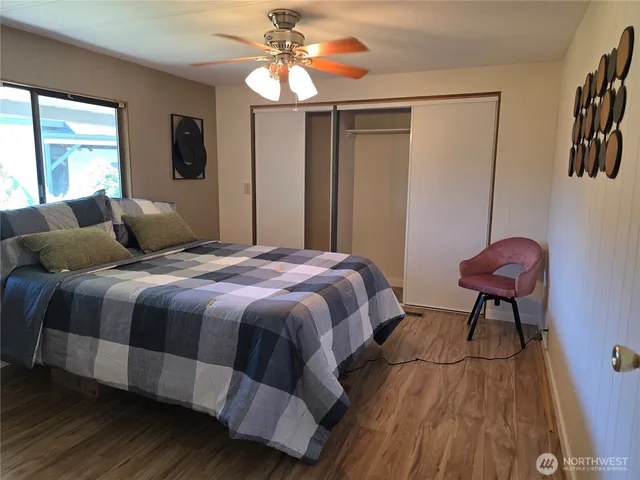 a bedroom with a bed and a mirror