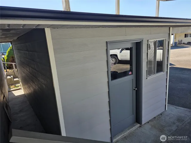 a view of empty room with wooden walls