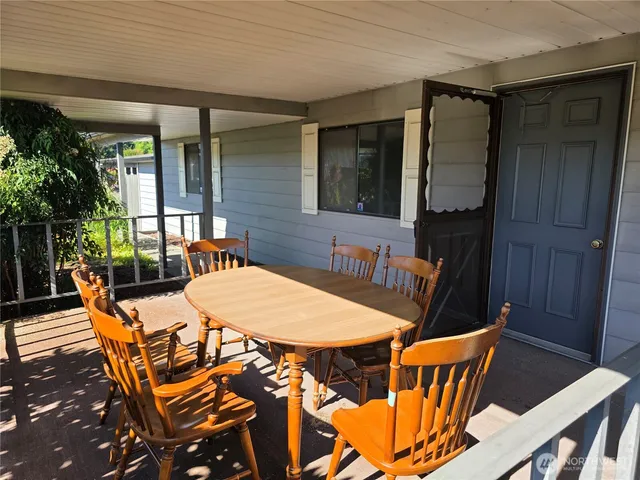 a view of a chairs and table in a balcony