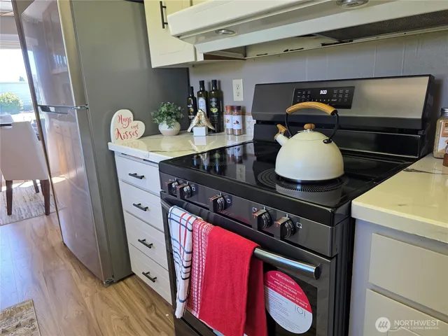 a kitchen with a stove and a refrigerator