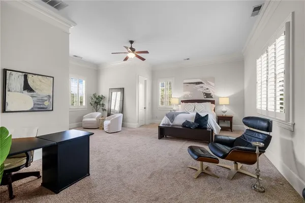 a bedroom with a large bed and a flat tv screen on dresser