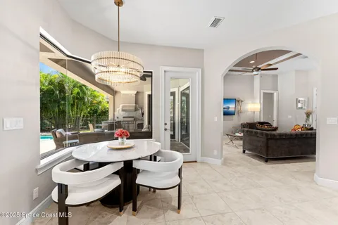 a living room with furniture a table and a chandelier