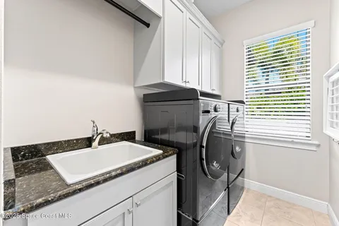 a bathroom with a sink a washer and dryer