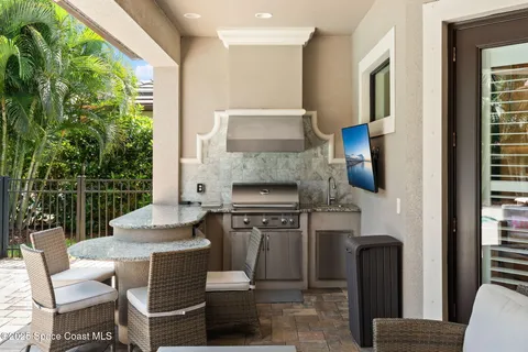 a living room with furniture a fireplace and a floor to ceiling window