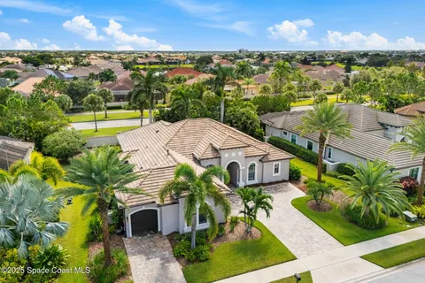 a aerial view of a house with a garden and lake view
