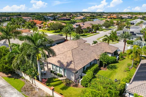 an aerial view of residential houses with outdoor space and trees