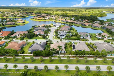 a view of a city with an ocean boats and trees all around
