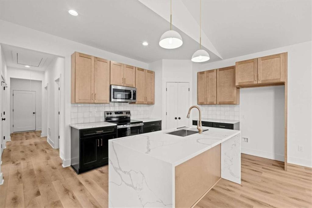 409 Lively Road Waco, GA 30182 - Photo 12 of 50 a kitchen with granite countertop a sink stove and cabinets