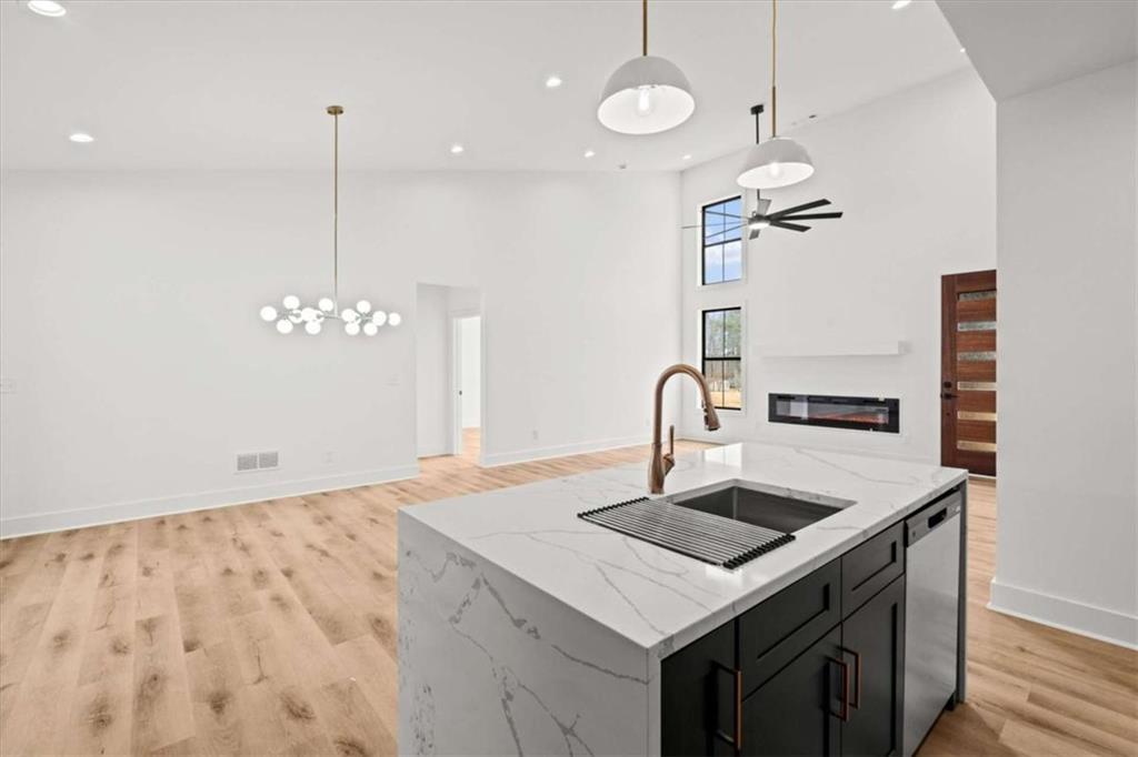 409 Lively Road Waco, GA 30182 - Photo 14 of 50 a kitchen that has a sink a stove and a table with chairs