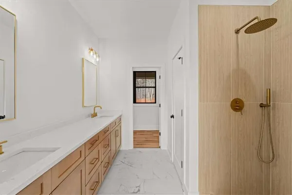 a bathroom with double sink and a mirror
