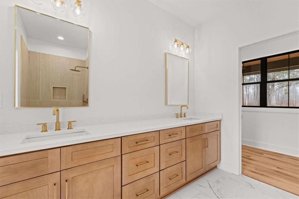 409 Lively Road Waco, GA 30182 - Photo 21 of 50 a bathroom with double sink and a mirror