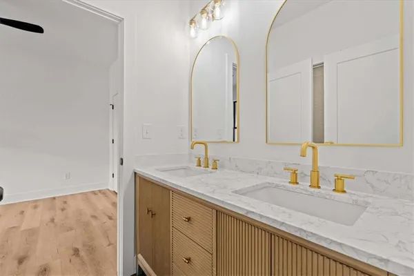 a bathroom with a granite countertop bathtub shower and toilet