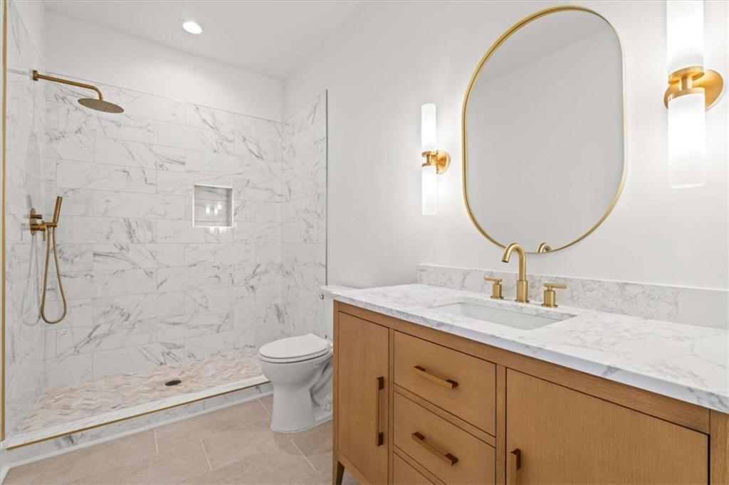 409 Lively Road Waco, GA 30182 - Photo 36 of 50 a bathroom with a granite countertop toilet a sink and a mirror