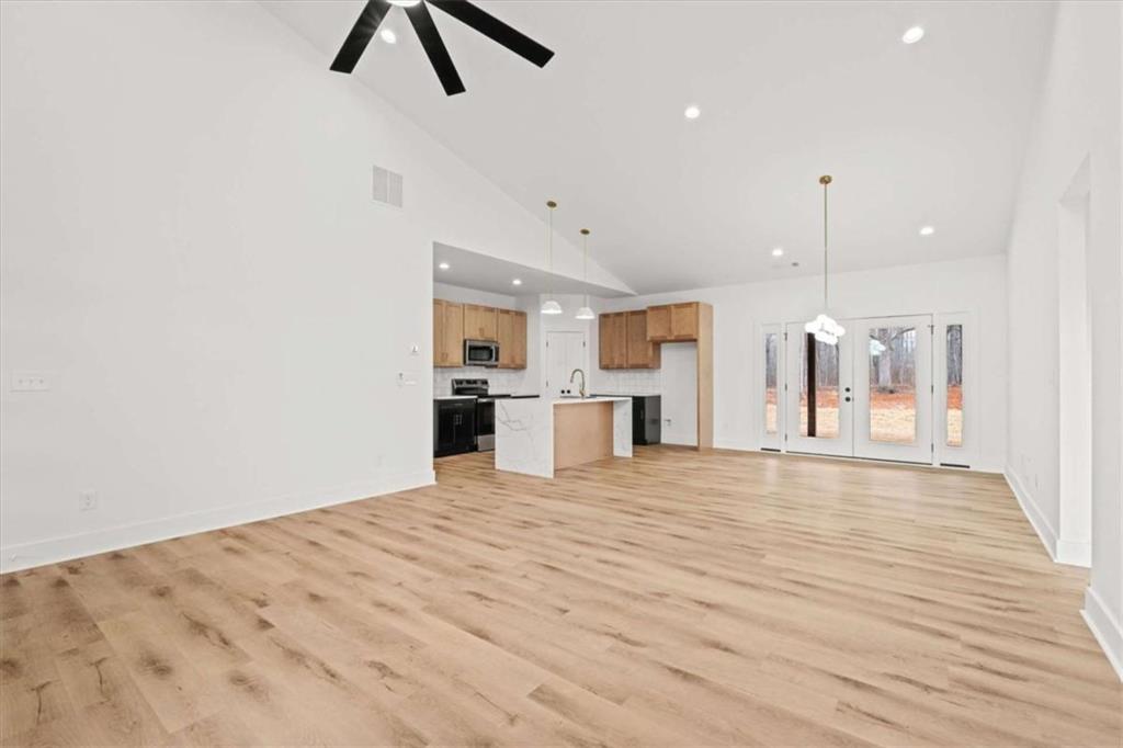 409 Lively Road Waco, GA 30182 - Photo 8 of 50 a view of kitchen and empty room with wooden floor