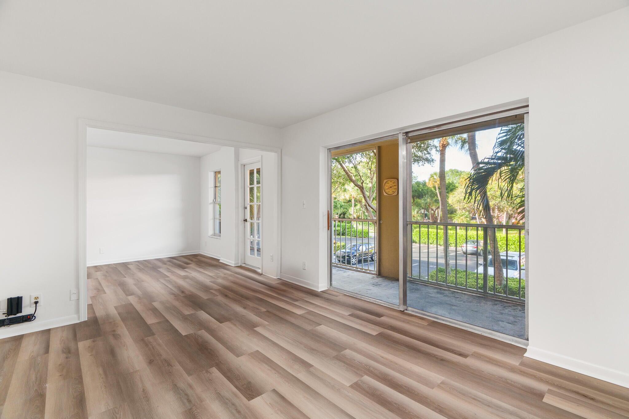 950 Ponce De Leon Road, Unit 208 Boca Raton, FL 33432 - Photo 13 of 43 a view of empty room with wooden floor and fan