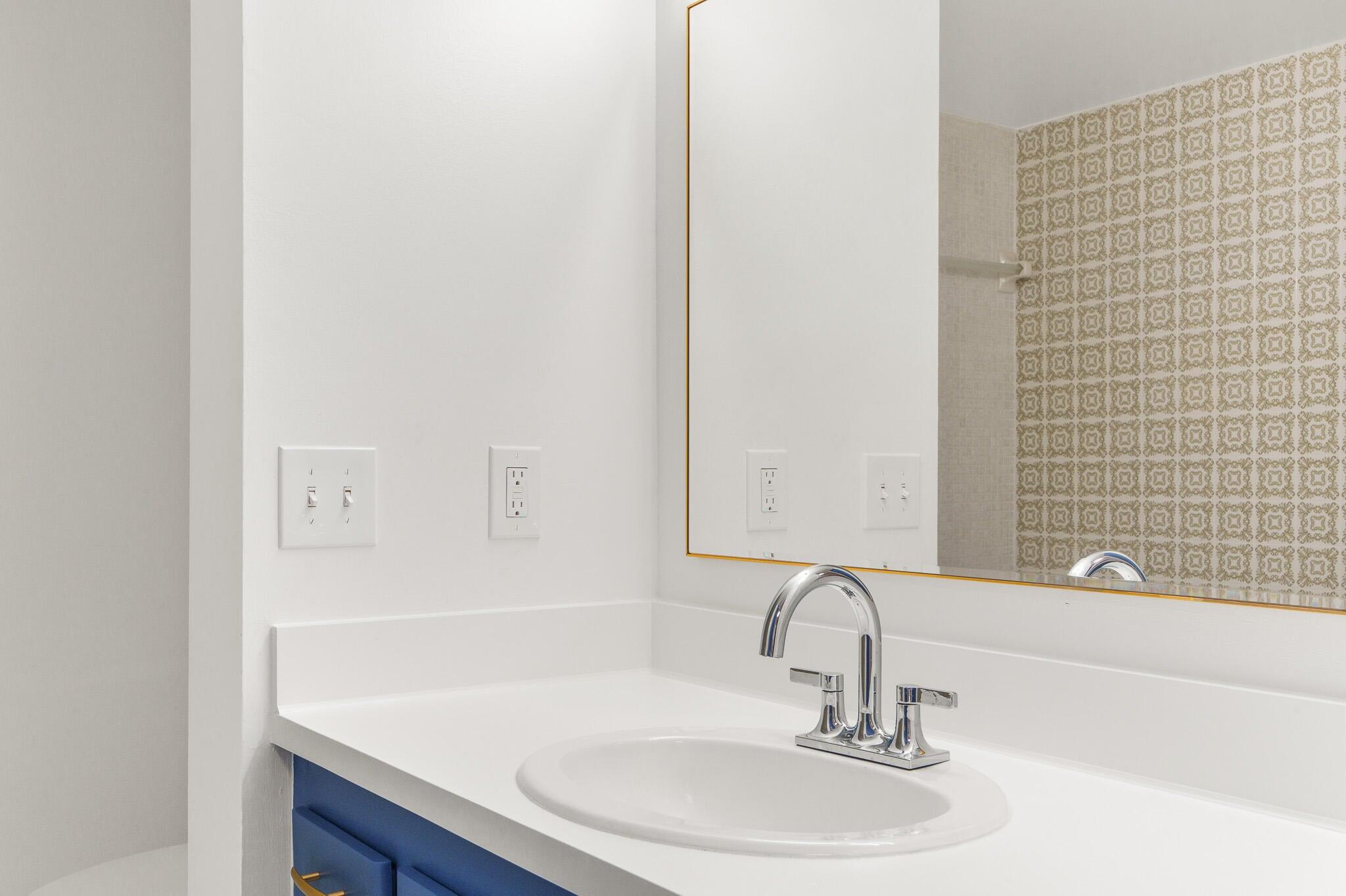 950 Ponce De Leon Road, Unit 208 Boca Raton, FL 33432 - Photo 24 of 43 a bathroom with a sink and a mirror