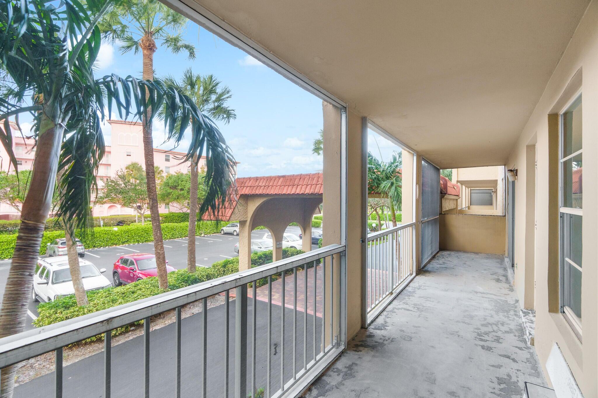 950 Ponce De Leon Road, Unit 208 Boca Raton, FL 33432 - Photo 26 of 43 a view of hallway with wooden floor and fence