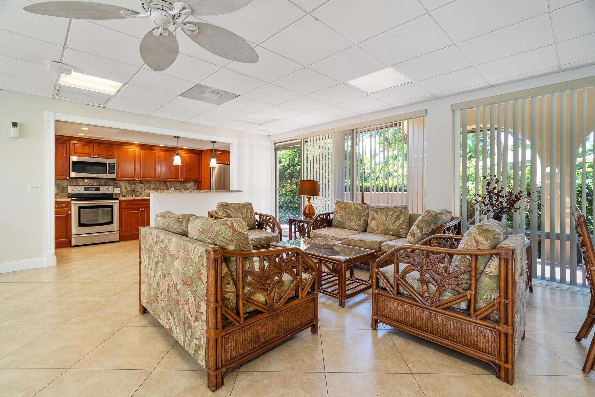 950 Ponce De Leon Road, Unit 208 Boca Raton, FL 33432 - Photo 33 of 43 a living room with furniture and a flat screen tv