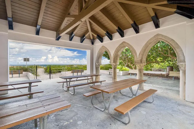 a view of a patio with table and chairs with wooden floor and fence