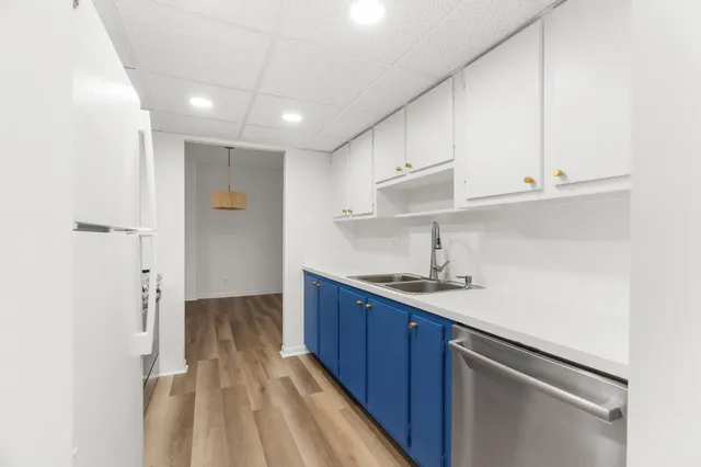 a kitchen with a sink stainless steel appliances and cabinets