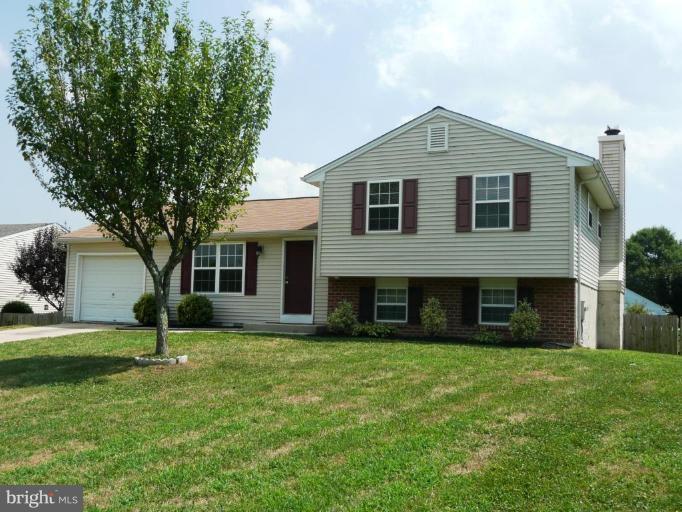 4713 East Joppa Road Nottingham, MD 21236 - Photo 1 of 24 a front view of a house with a yard and garage