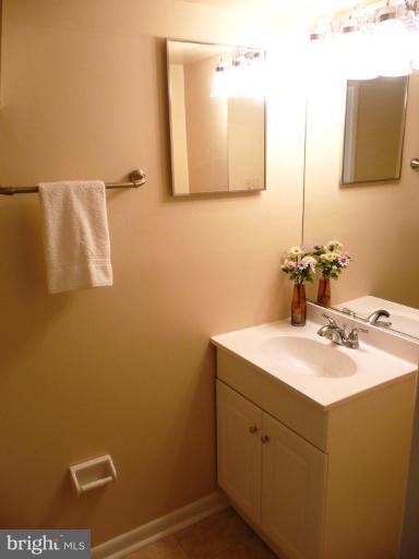 4713 East Joppa Road Nottingham, MD 21236 - Photo 13 of 24 a bathroom with a sink vanity and a mirror
