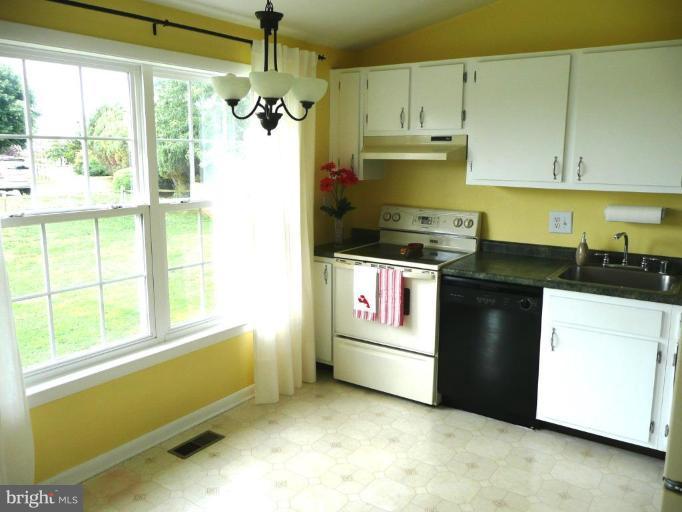 4713 East Joppa Road Nottingham, MD 21236 - Photo 15 of 24 a kitchen with granite countertop a refrigerator and a stove