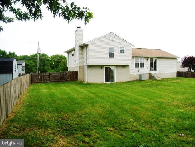 4713 East Joppa Road Nottingham, MD 21236 - Photo 3 of 24 a front view of a house with a yard and trees