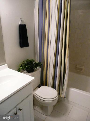 4713 East Joppa Road Nottingham, MD 21236 - Photo 5 of 24 a bathroom with a toilet and a shower curtain