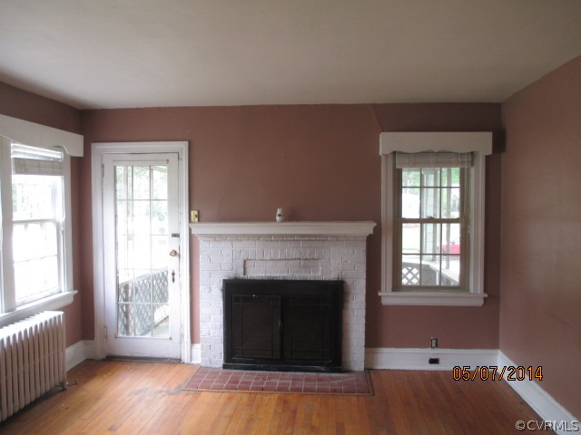 2705 West City Point Road Hopewell, VA 23860 - Photo 2 of 12 a living room with a fireplace and wooden floor
